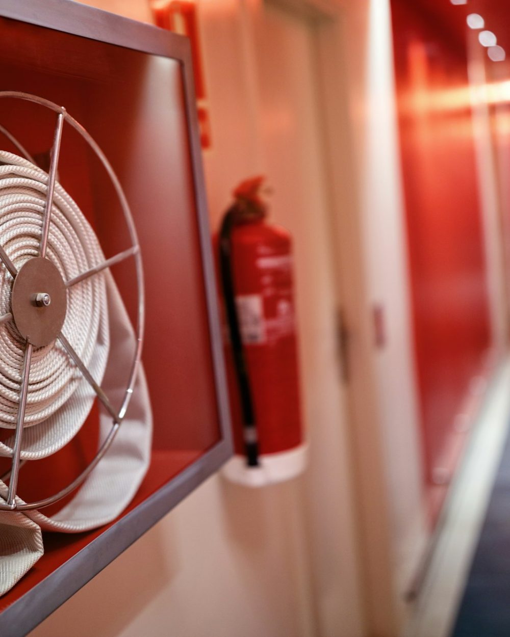 Fire extinguisher and hose reel in hotel corridor