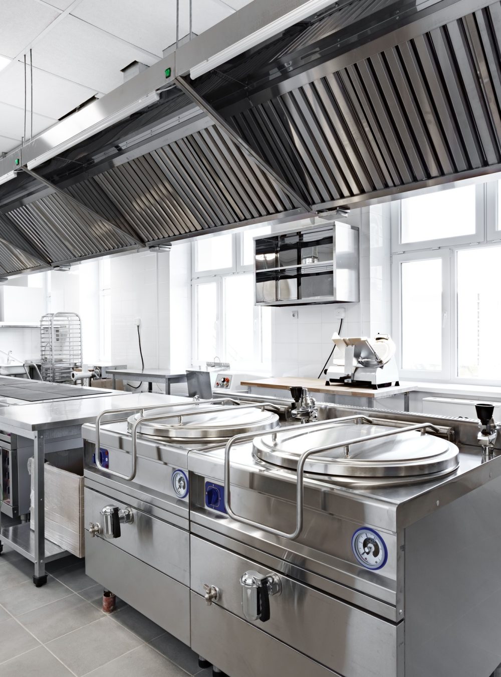 Modern commercial kitchen equipped with stainless steel appliances and ventilation system for Modern commercial kitchen equipped with stainless steel appliances and ventilation system for